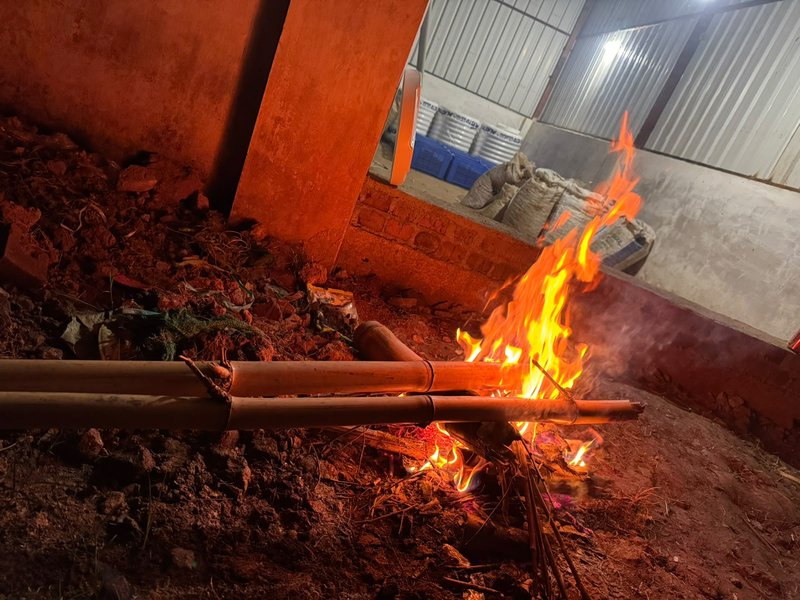 Night campfire outside coffee processing mill